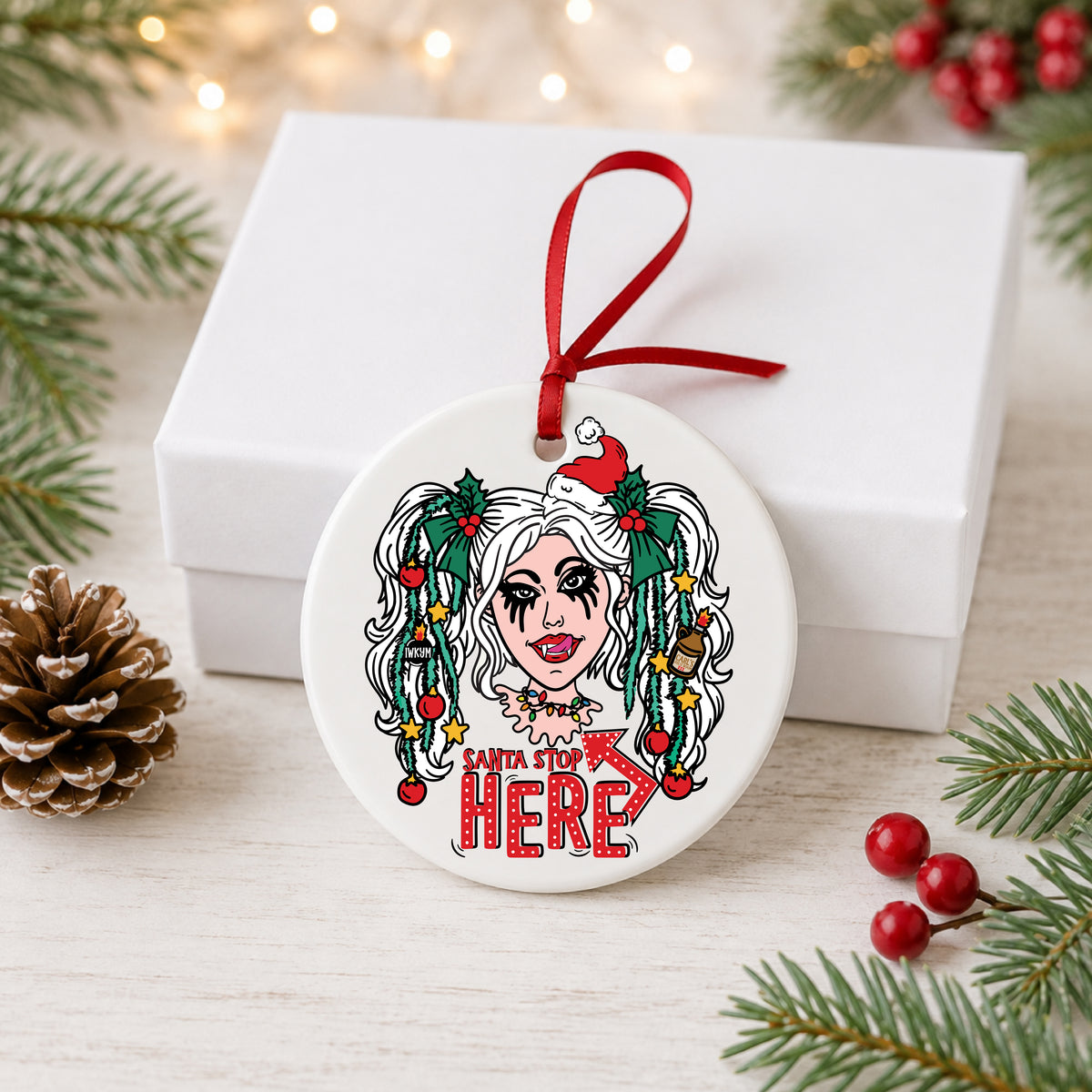 Dungeon Crawler Carl Samantha Santa Stop Here ornament hanging beside a white gift box
