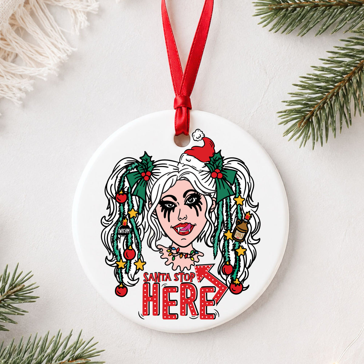 Dungeon Crawler Carl Samantha Santa Stop Here ornament flat lay on white with greenery
