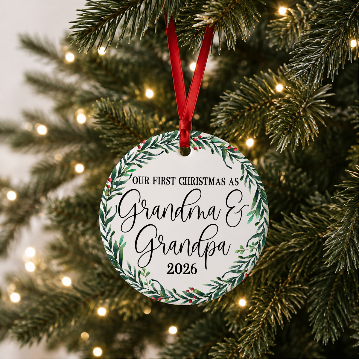 Our First Christmas as Grandma and Grandpa ornament hanging on a glowing Christmas tree