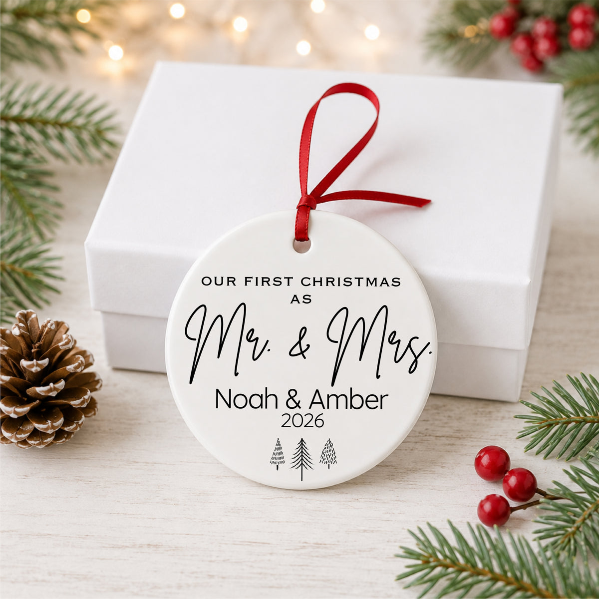 Personalized Mr and Mrs first Christmas ornament displayed with a white gift box
