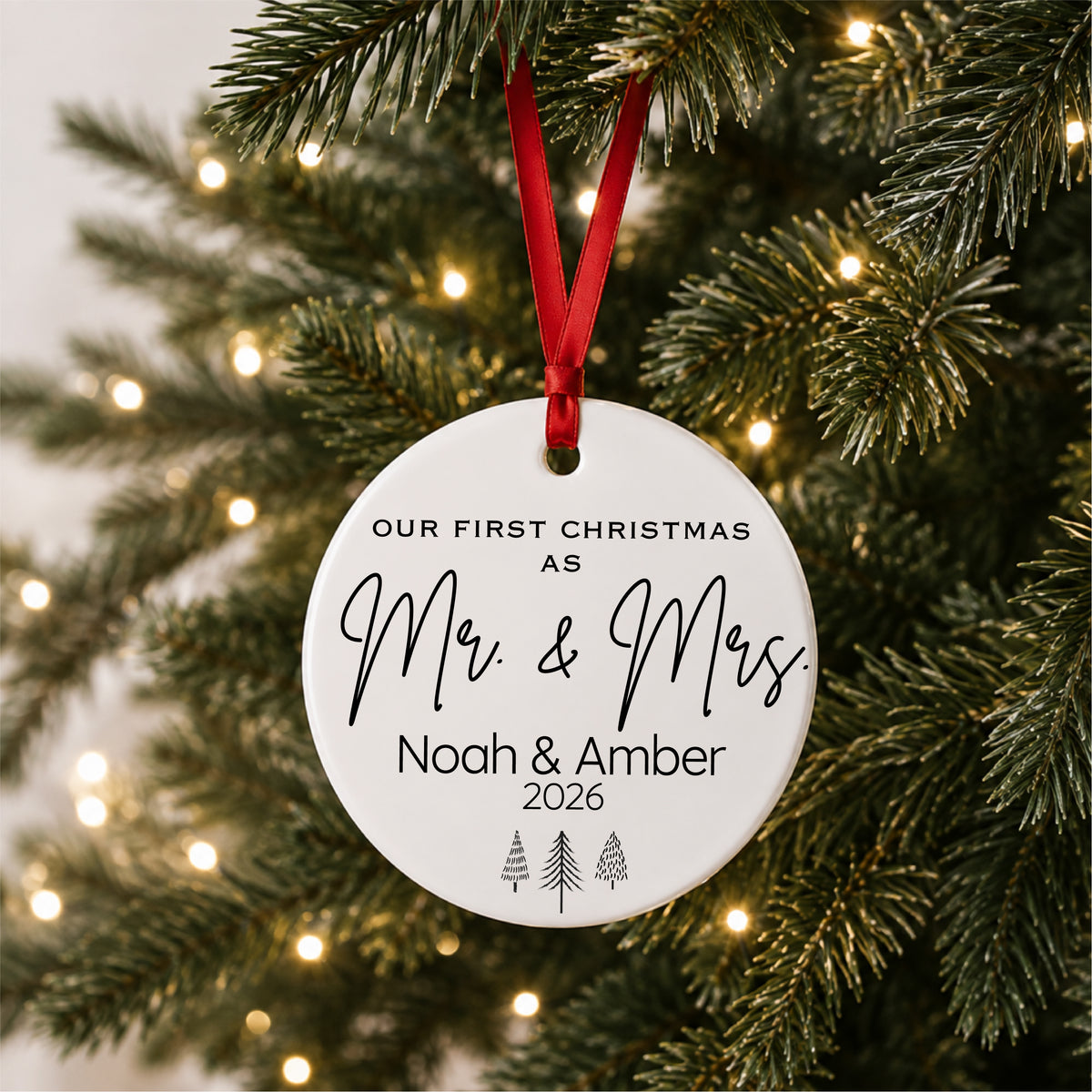 Our First Christmas as Mr and Mrs ornament hanging on a glowing Christmas tree