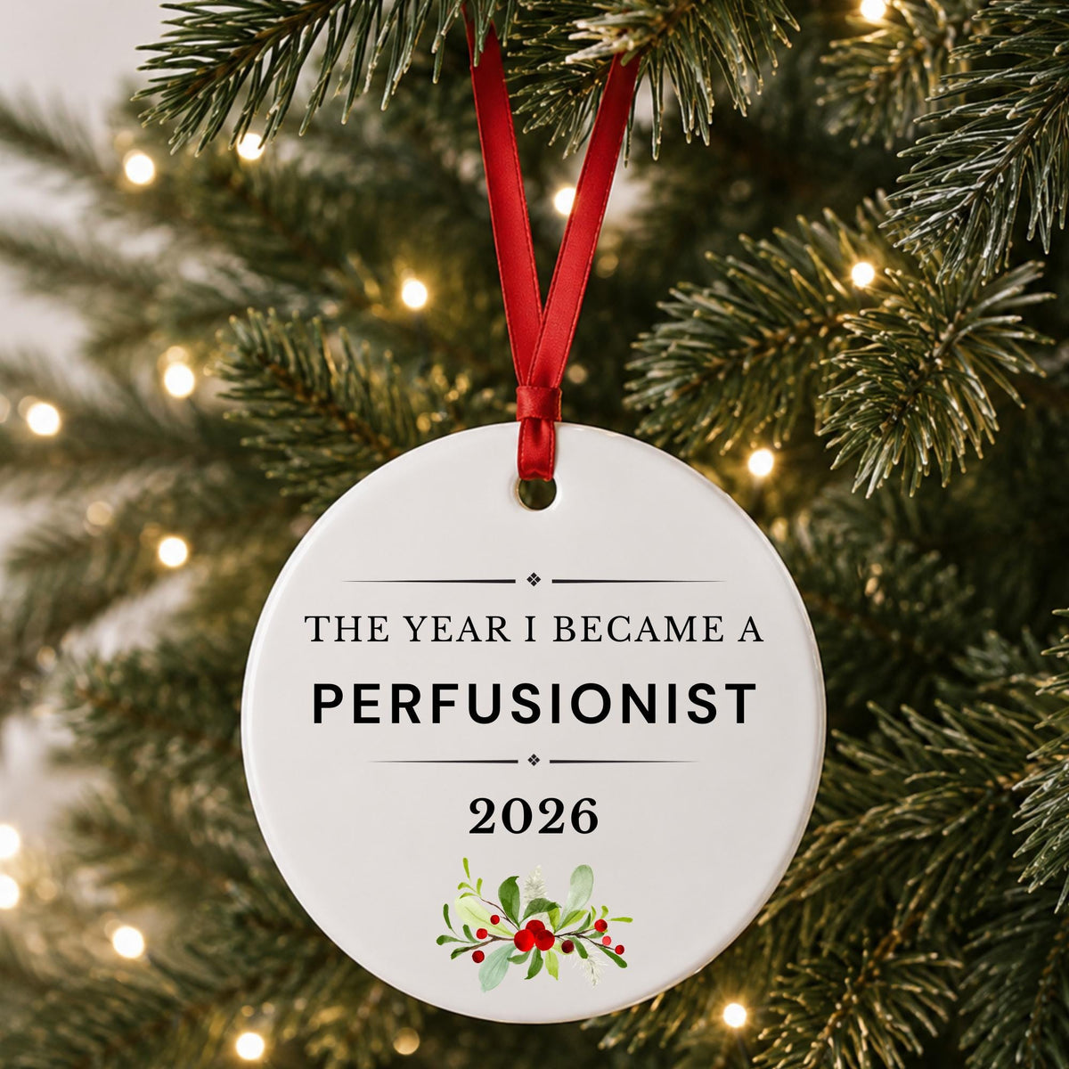 Perfusionist 2026 ceramic ornament reading The Year I Became a Perfusionist hanging on a lit Christmas tree