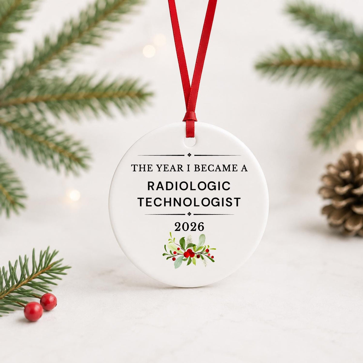 Radiologic Technologist 2026 ceramic ornament reading The Year I Became a Radiologic Technologist with red ribbon on a white surface with pine branches and pinecones