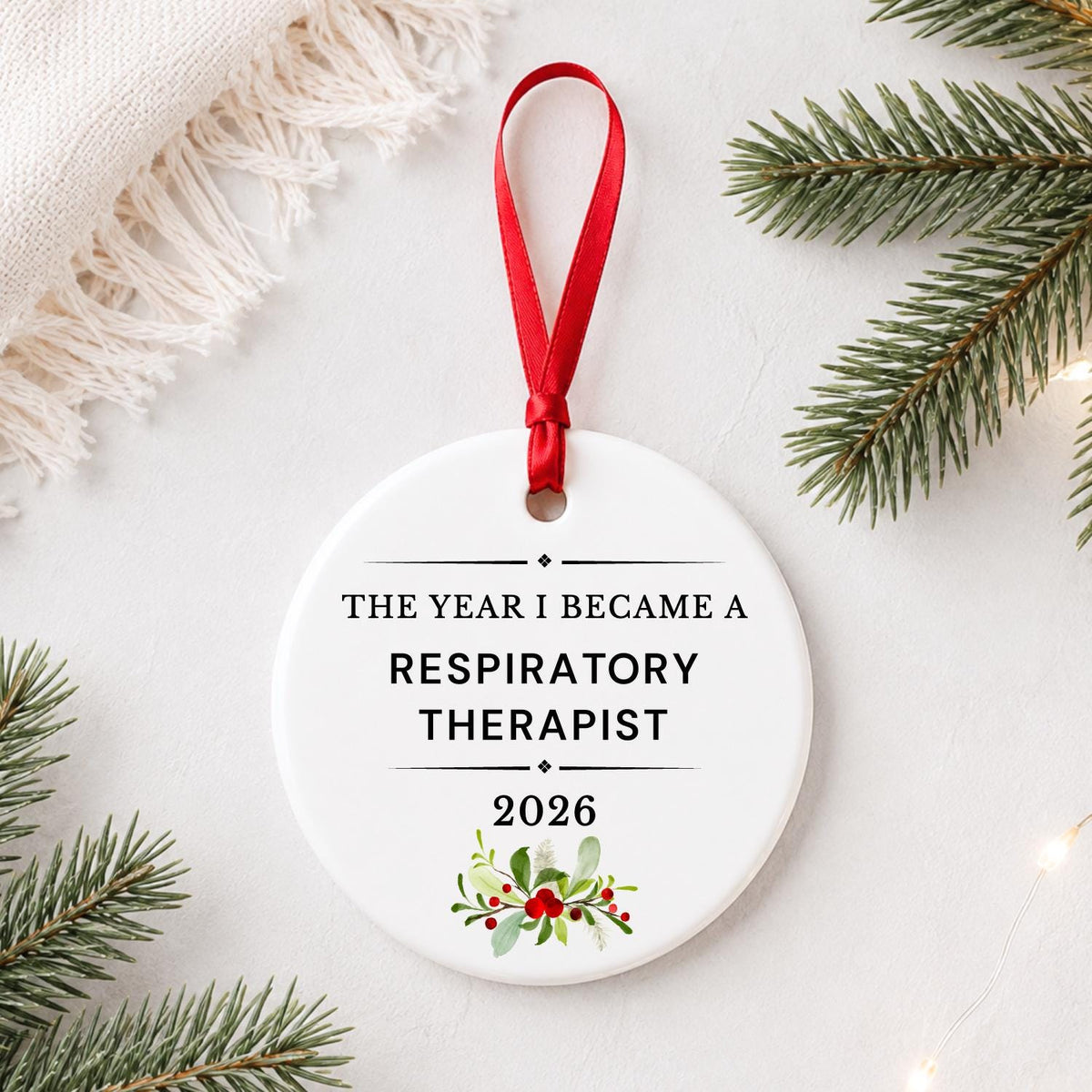 Respiratory Therapist 2026 ceramic ornament reading The Year I Became a Respiratory Therapist styled with pine branches on a soft white background