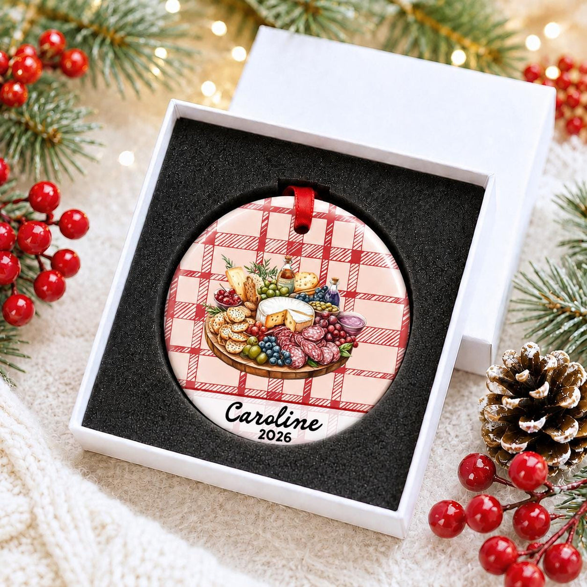 Personalized charcuterie board ceramic ornament with name and year on red plaid in a white gift box with protective foam