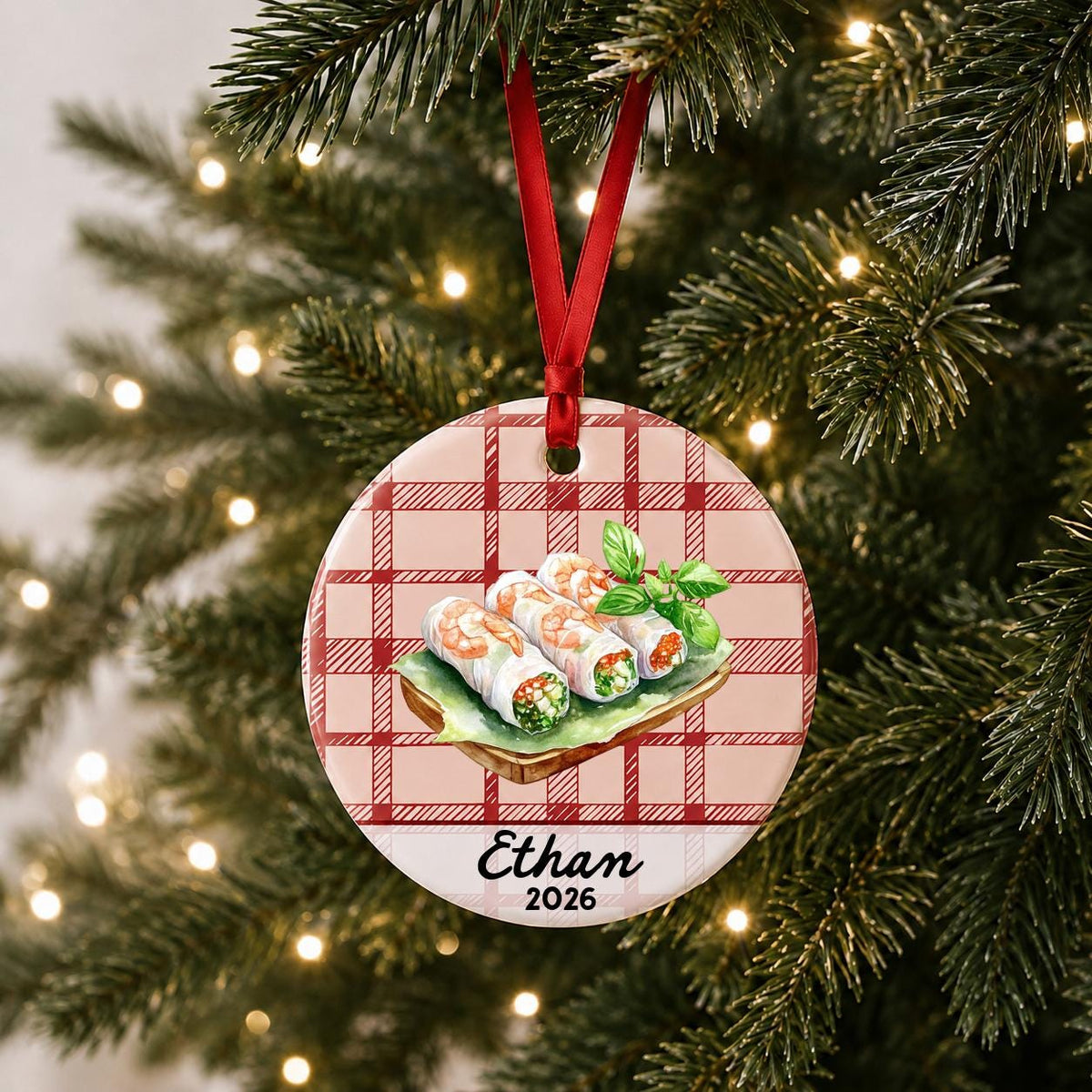 Personalized fresh spring rolls ceramic ornament with name and year on red plaid hanging on a lit Christmas tree