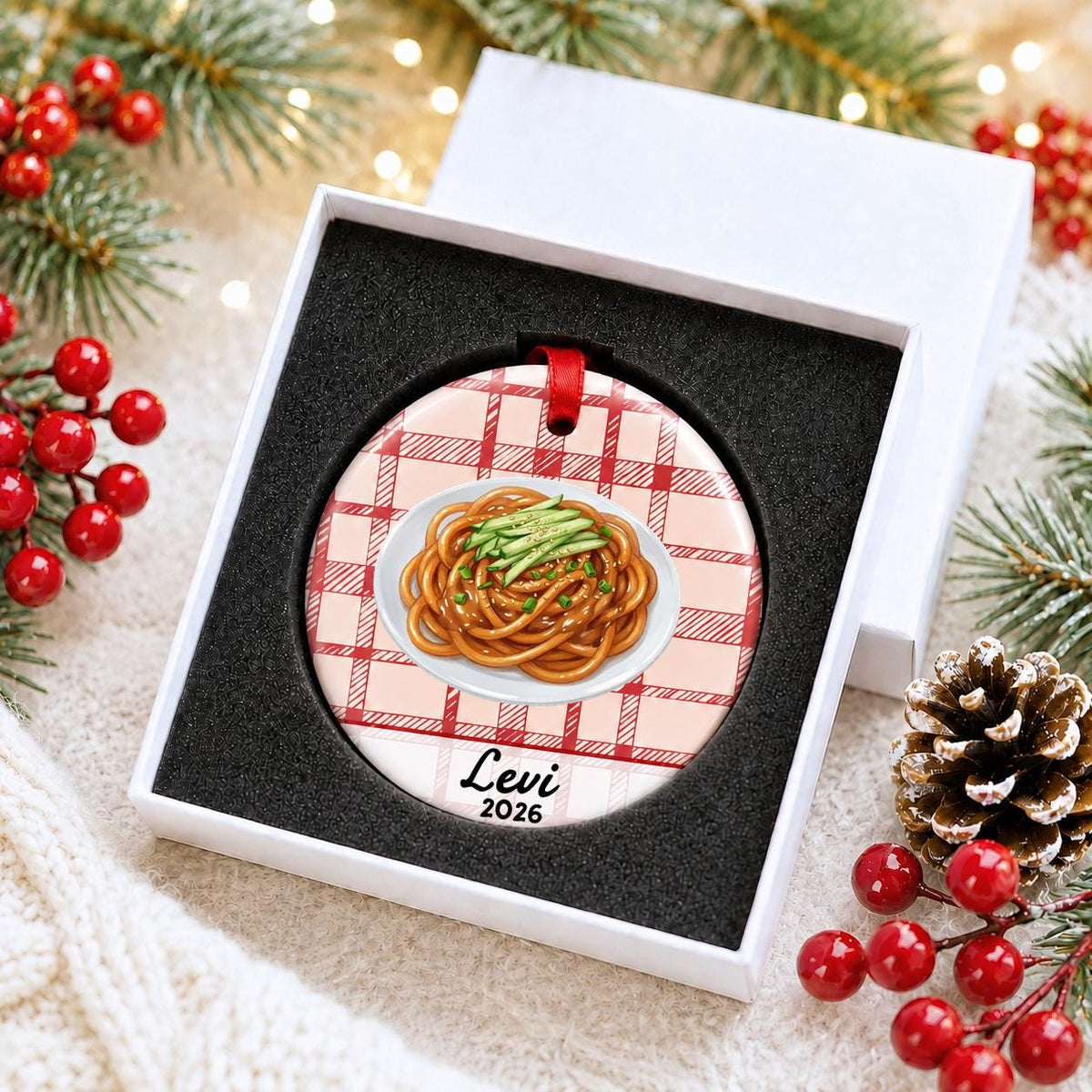 Personalized sesame noodles ceramic ornament with name and year on red plaid in a white gift box with protective foam