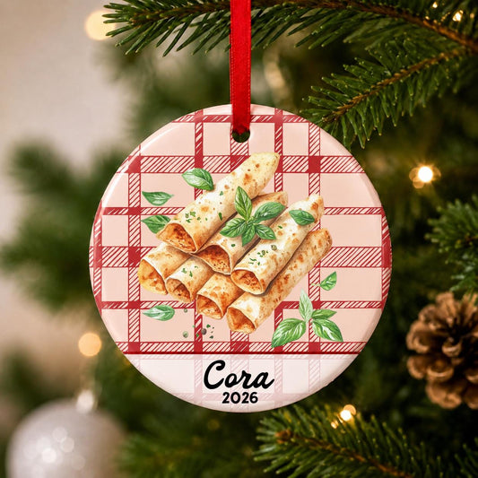 Close-up of the personalized taquito ceramic ornament with name and year on red plaid hanging on a Christmas tree