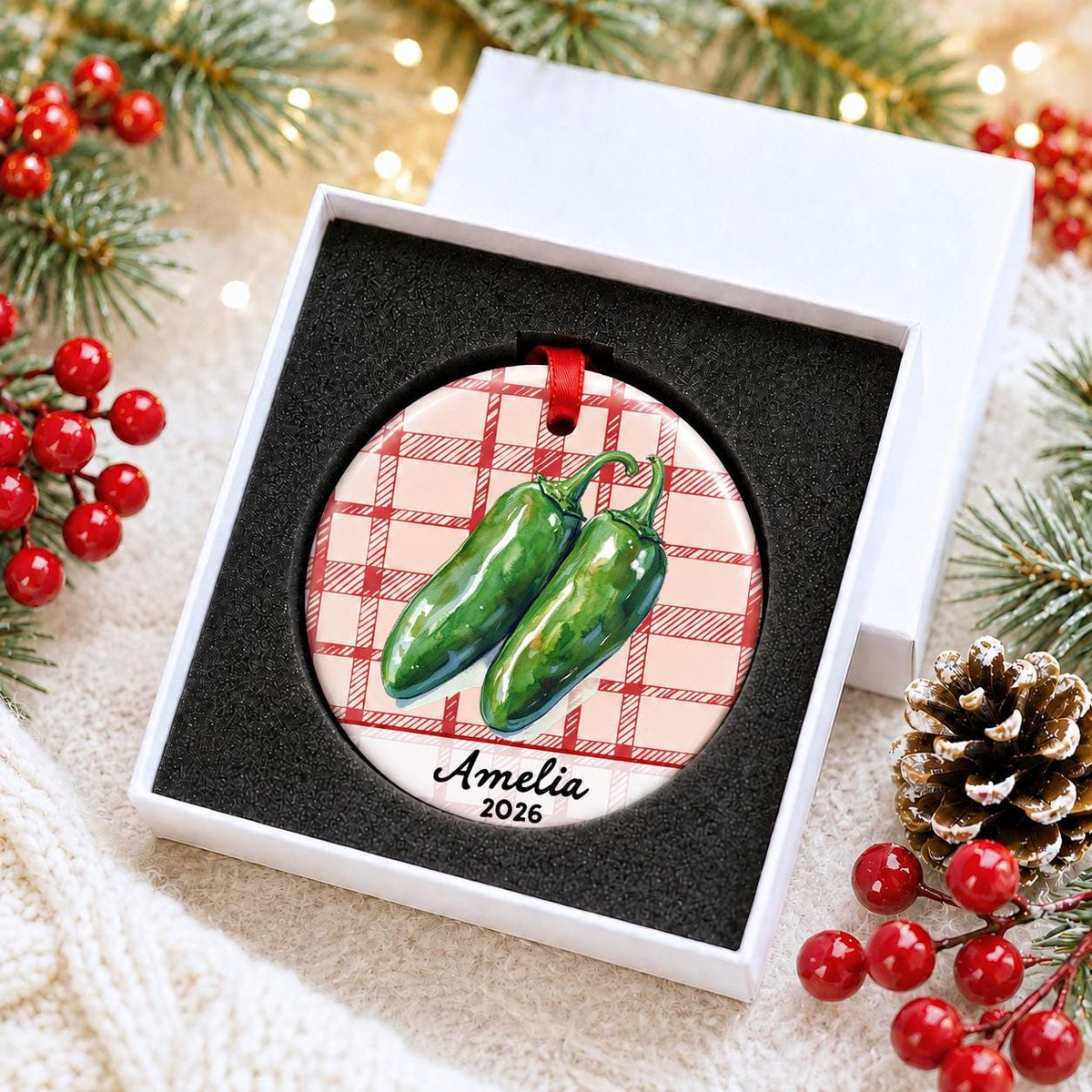 Personalized jalapeño ceramic ornament with name and year on red plaid in a white gift box with protective foam