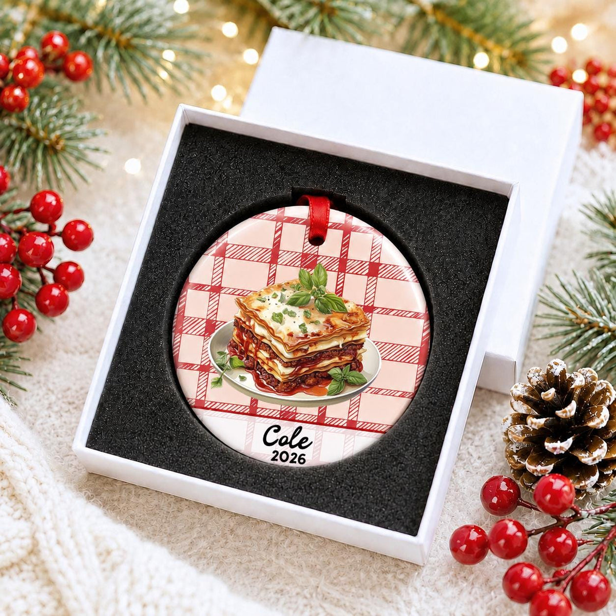 Personalized lasagna ceramic ornament with name and year on red plaid in a white gift box with protective foam
