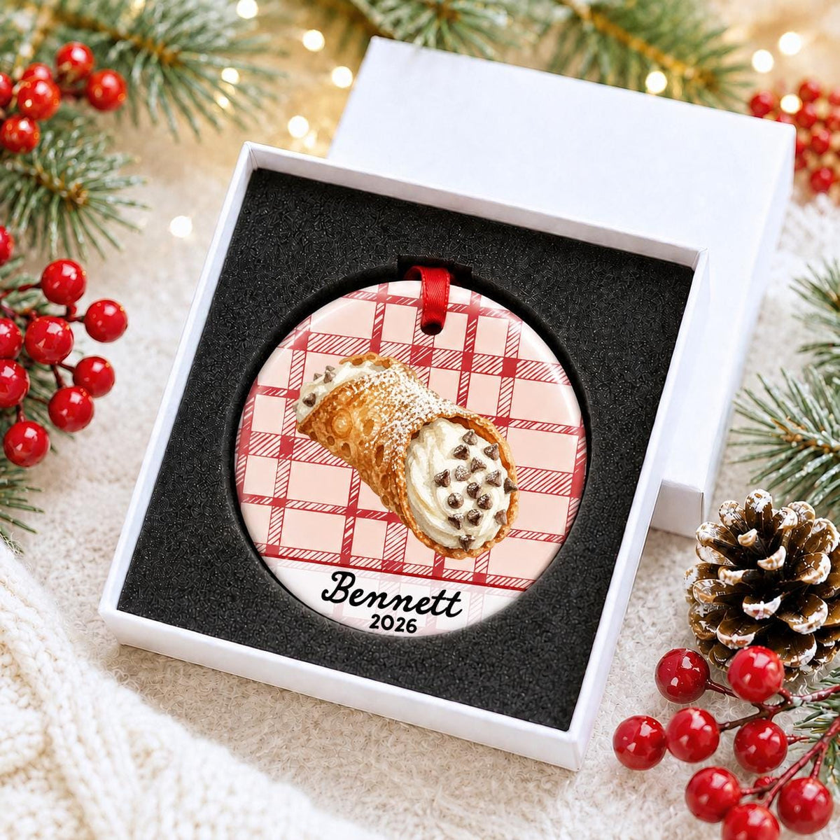 Personalized cannoli ceramic ornament with name and year on red plaid in a white gift box with protective foam