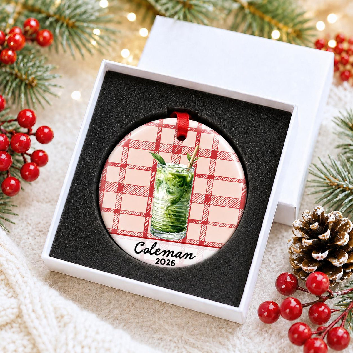 Personalized iced matcha ceramic ornament with name and year on red plaid in a white gift box with protective foam