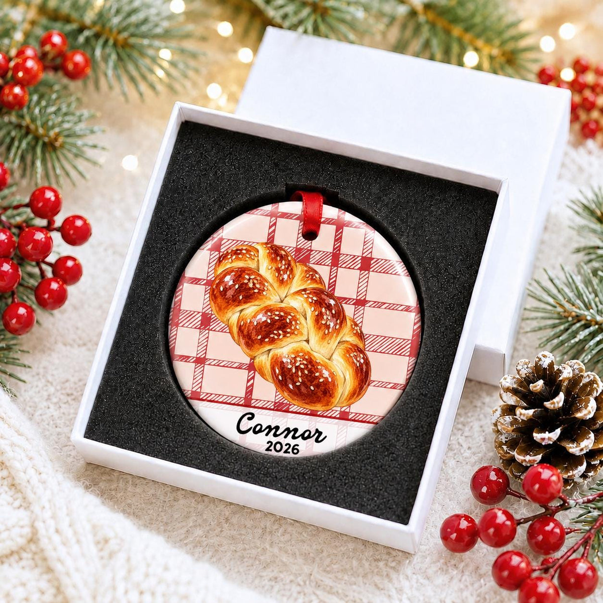 Personalized challah bread ceramic ornament with name and year on red plaid in a white gift box with protective foam