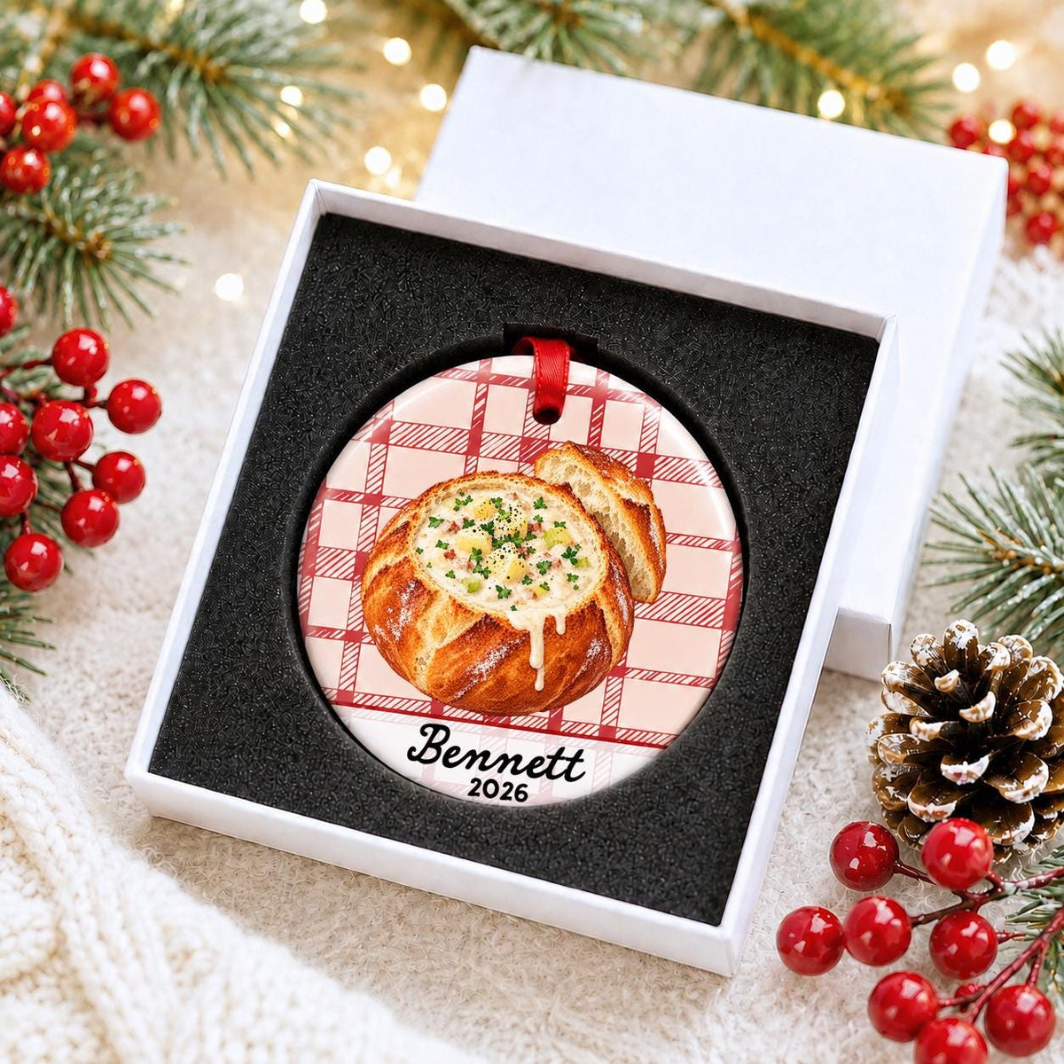Personalized clam chowder bread bowl ceramic ornament with name and year on red plaid in a white gift box with protective foam