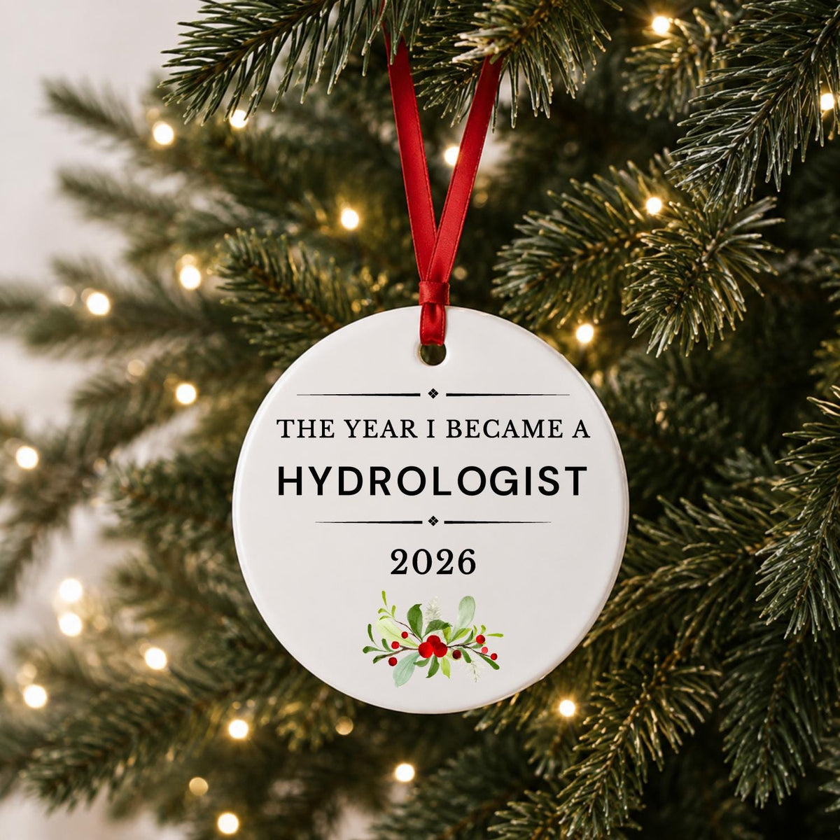 Hydrologist 2026 ceramic ornament reading The Year I Became a Hydrologist hanging on a lit Christmas tree