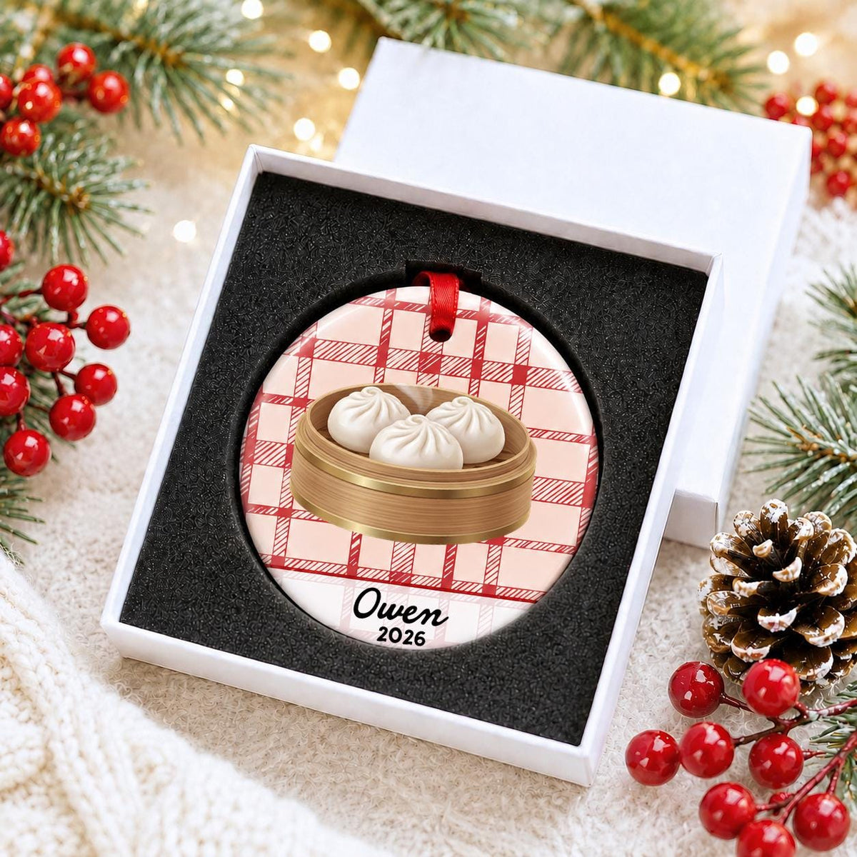 Personalized soup dumpling ceramic ornament with name and year on red plaid in a white gift box with protective foam