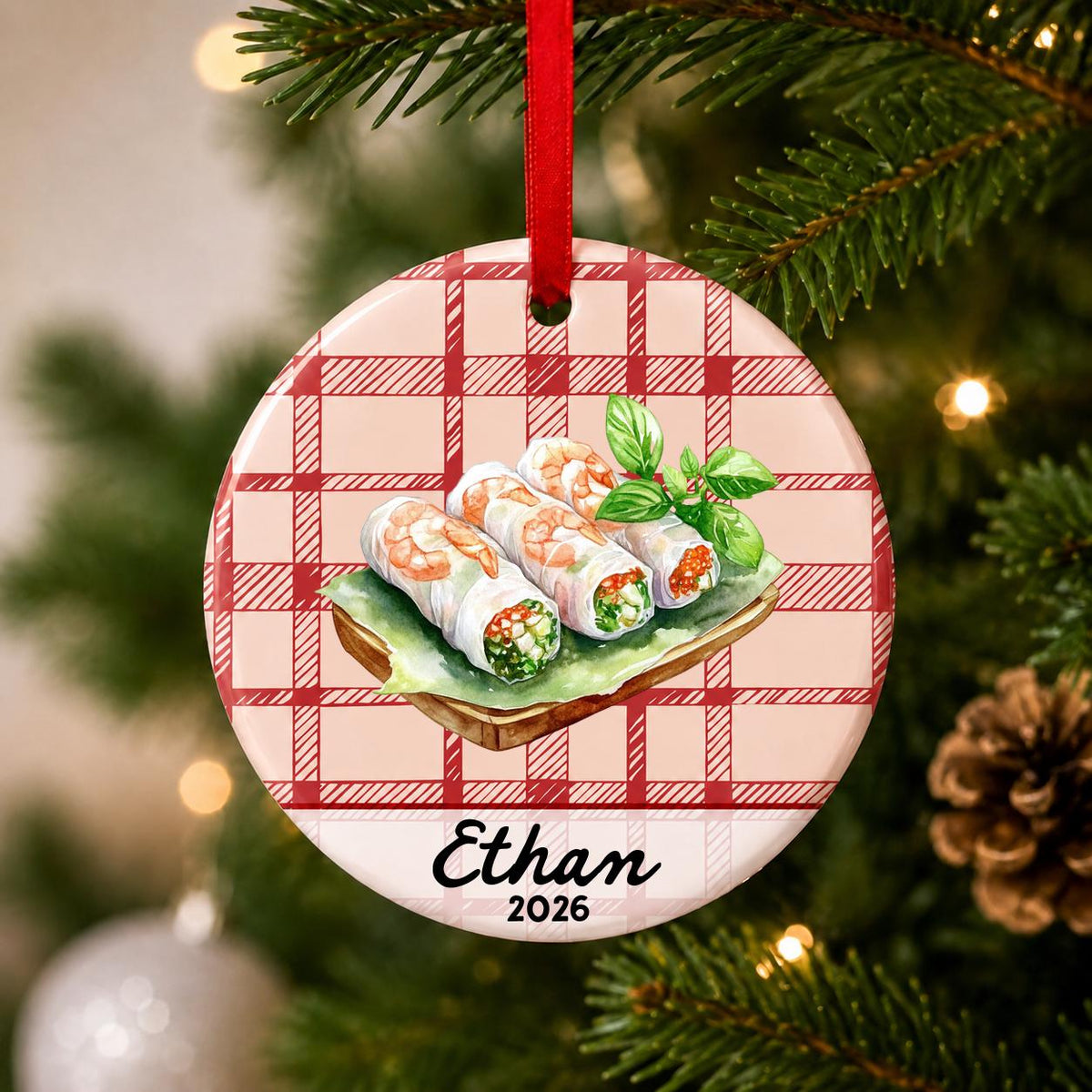 Close-up of the personalized fresh spring rolls ceramic ornament with name and year on red plaid hanging on a Christmas tree