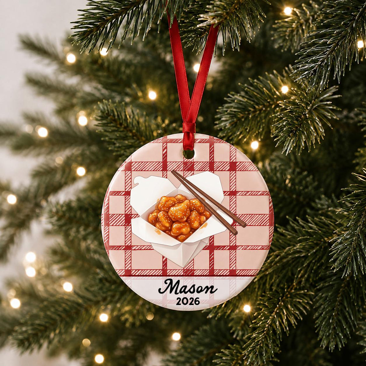 Personalized sesame chicken ceramic ornament with name and year on red plaid hanging on a lit Christmas tree