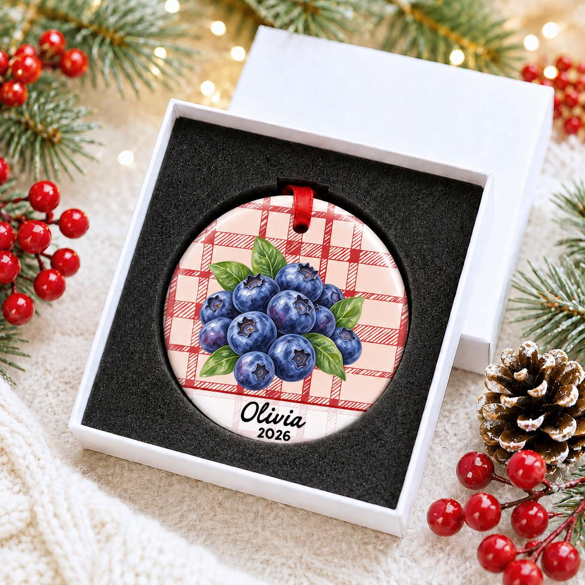 Personalized blueberries ceramic ornament with name and year on red plaid in a white gift box with protective foam