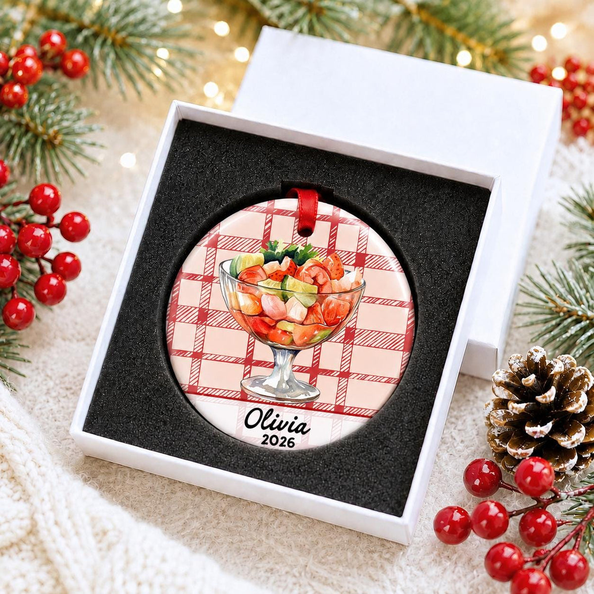 Personalized shrimp cocktail ceramic ornament with name and year on red plaid in a white gift box with protective foam