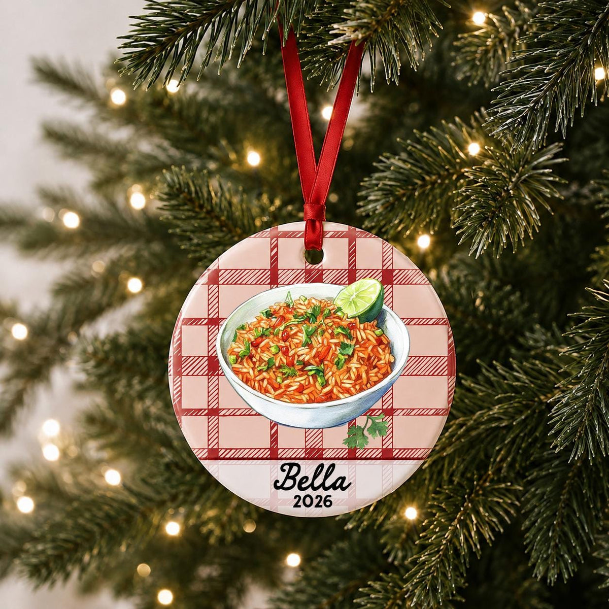 Personalized Mexican rice ceramic ornament with name and year on red plaid hanging on a lit Christmas tree