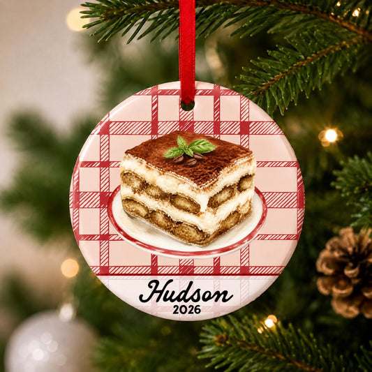 Close-up of the personalized tiramisu ceramic ornament with name and year on red plaid hanging on a Christmas tree