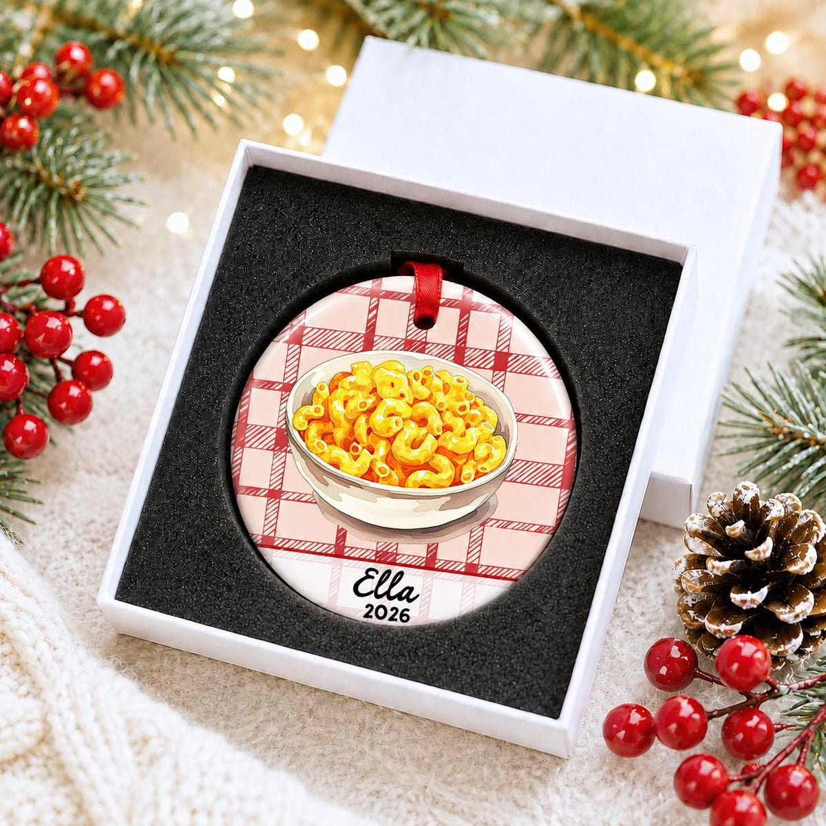 Personalized mac and cheese ceramic ornament with name and year on red plaid in a white gift box with protective foam