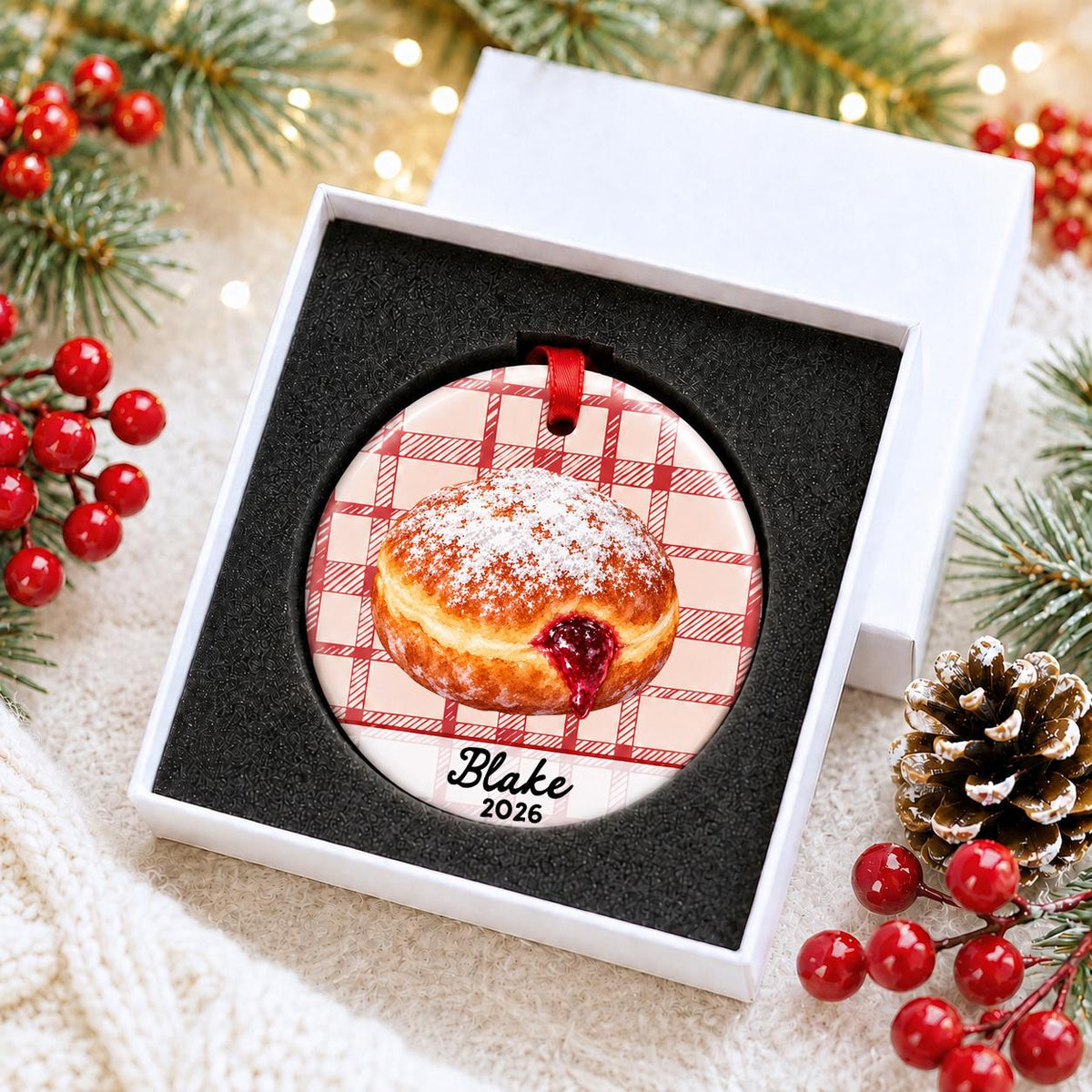 Personalized paczki ceramic ornament with name and year on red plaid in a white gift box with protective foam