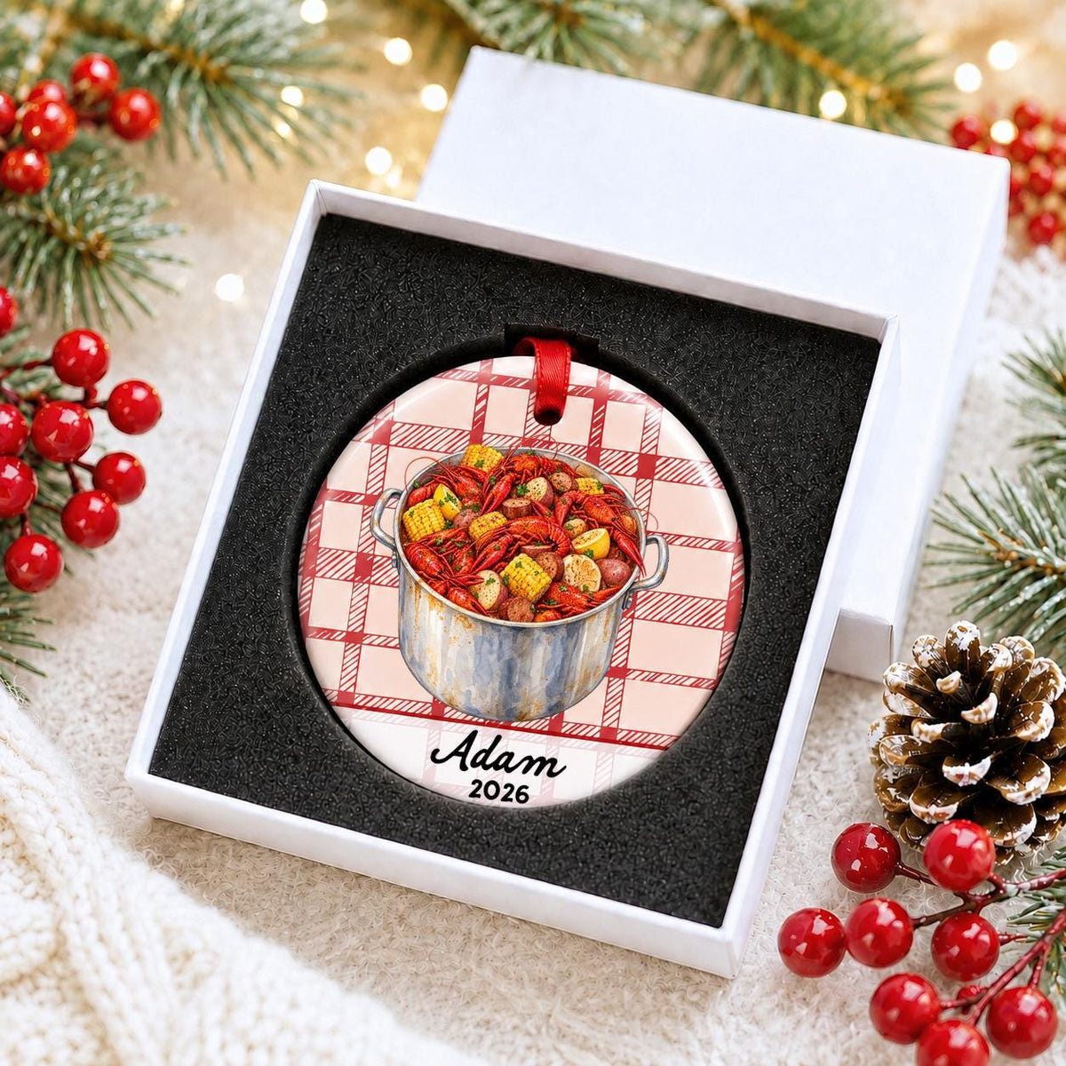 Personalized crawfish boil ceramic ornament with name and year on red plaid in a white gift box with protective foam