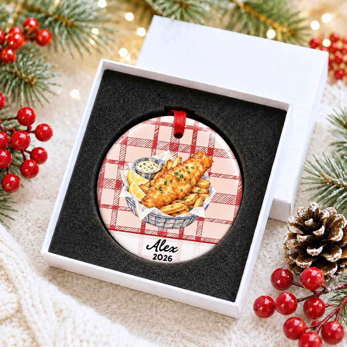 Personalized fish and chips ceramic ornament with name and year on red plaid in a white gift box with protective foam