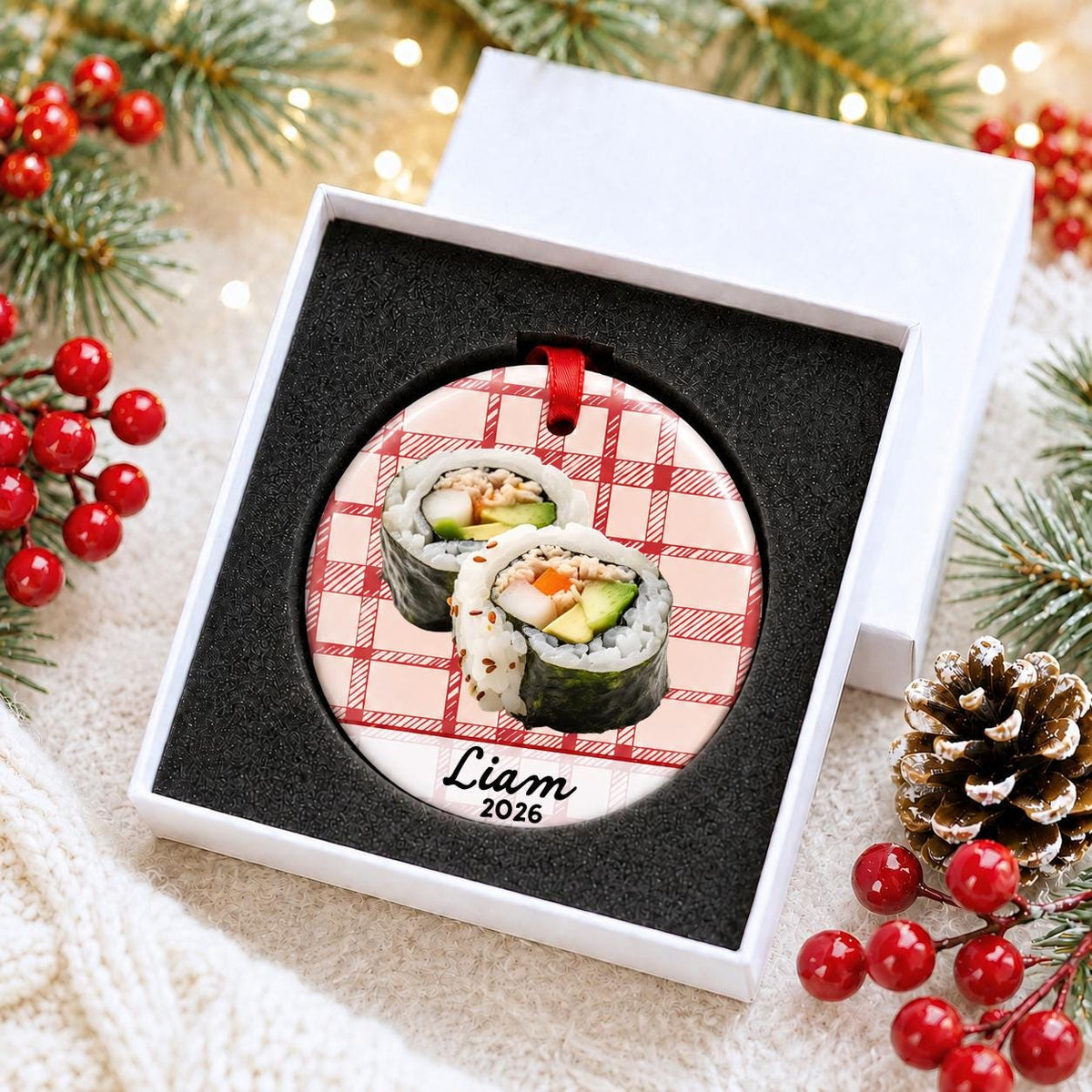Personalized sushi ceramic ornament with name and year on red plaid in a white gift box with protective foam