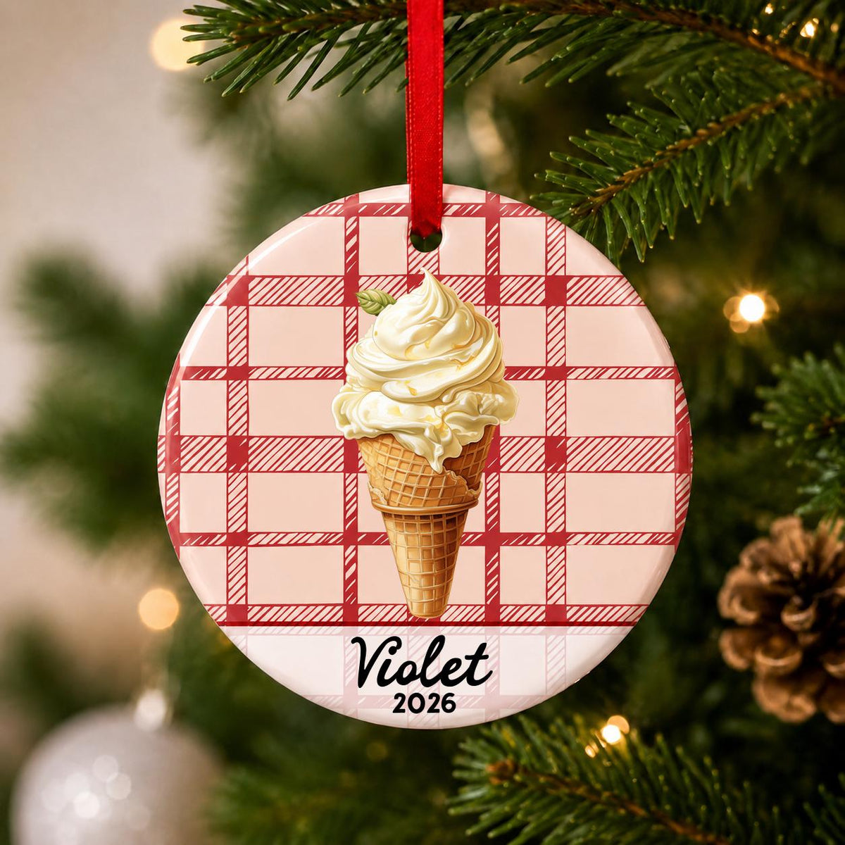 Close-up of the personalized soft serve ice cream ceramic ornament with name and year on red plaid hanging on a Christmas tree