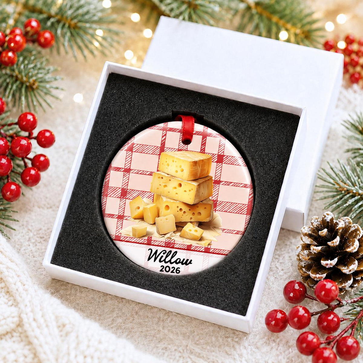 Personalized Swiss cheese ceramic ornament with name and year on red plaid in a white gift box with protective foam