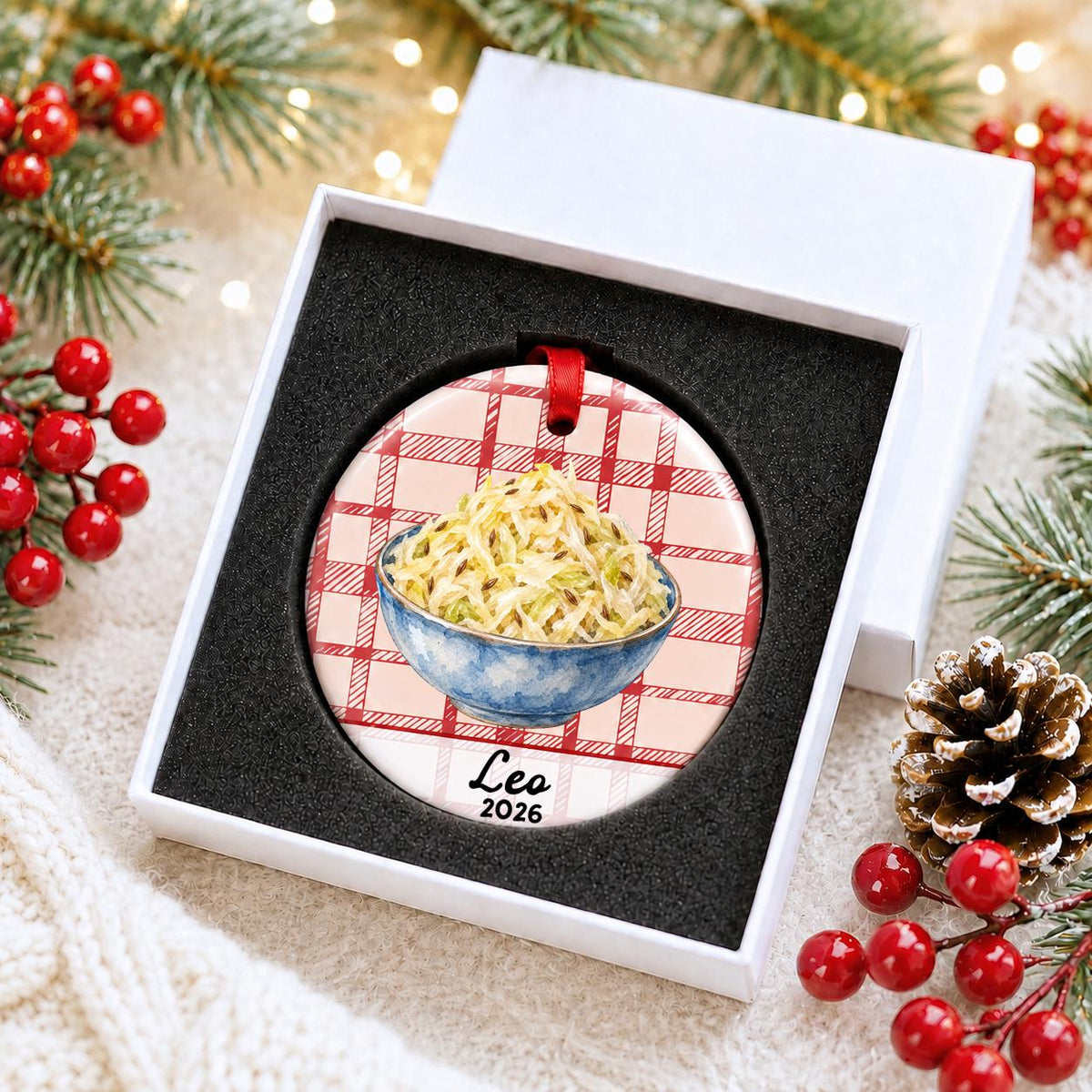Personalized sauerkraut ceramic ornament with name and year on red plaid in a white gift box with protective foam