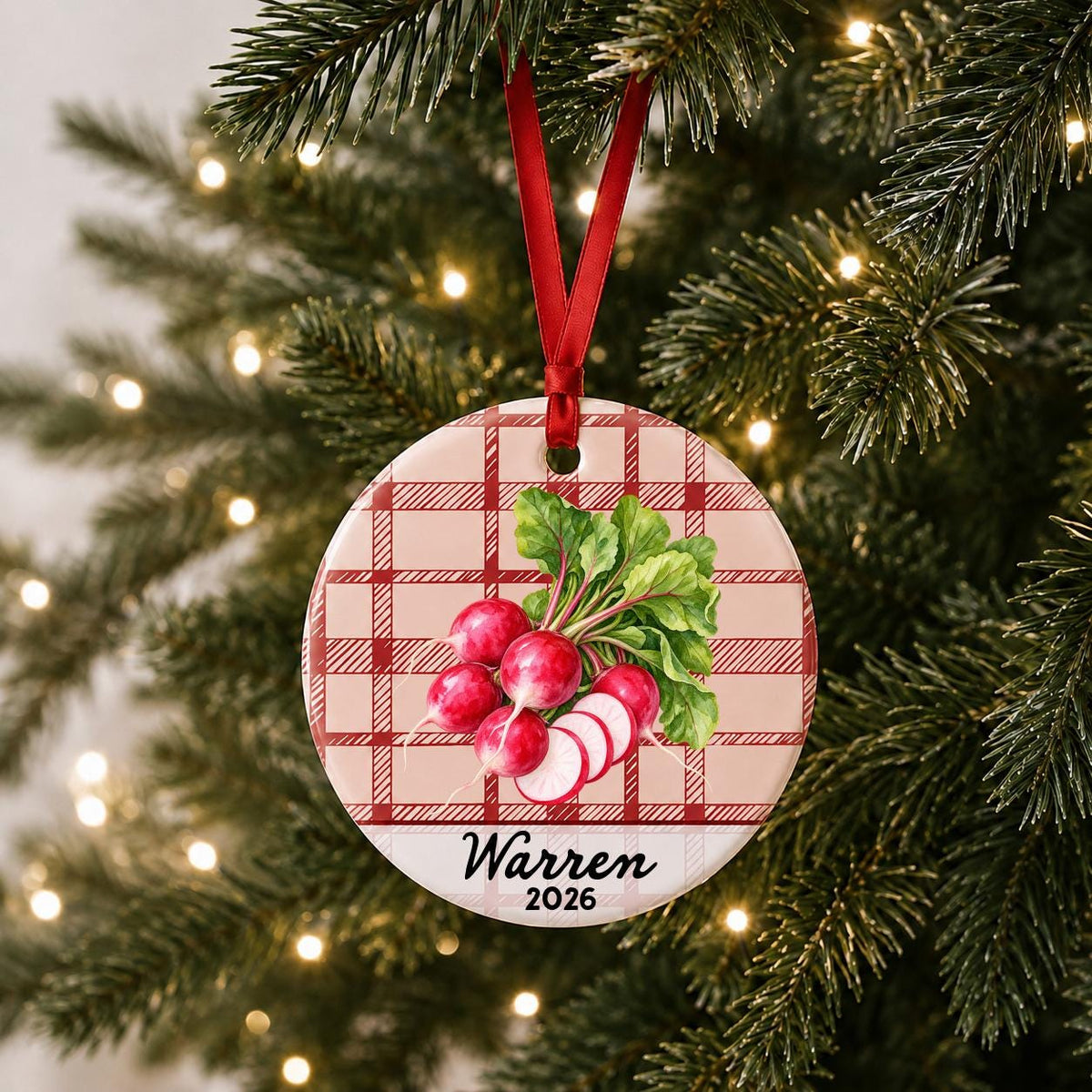 Personalized radishes ceramic ornament with name and year on red plaid hanging on a lit Christmas tree