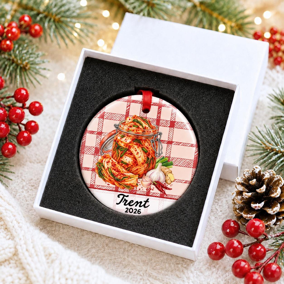 Personalized kimchi ceramic ornament with name and year on red plaid in a white gift box with protective foam