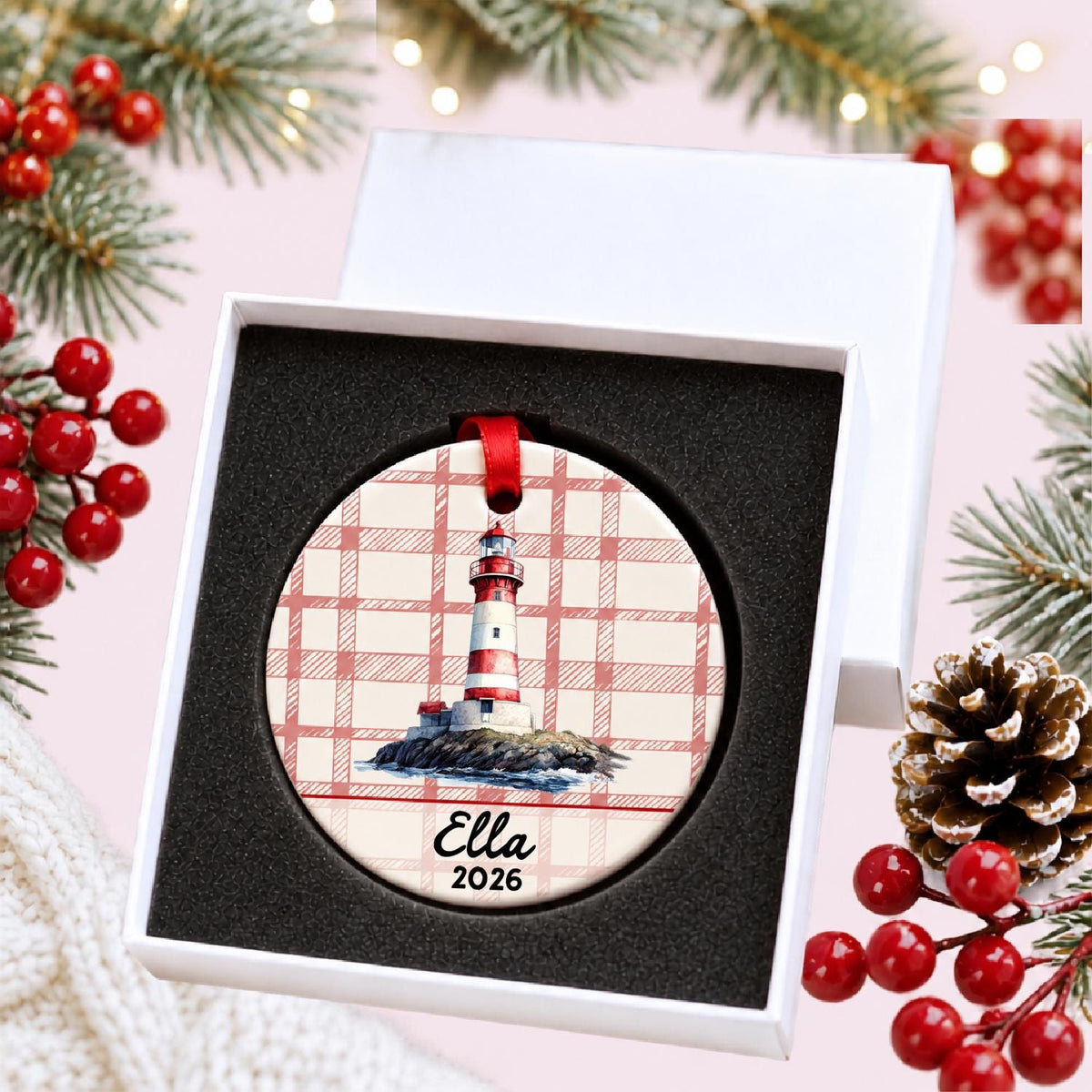 Personalized island lighthouse ceramic ornament with name and year on red plaid in a white gift box with protective foam