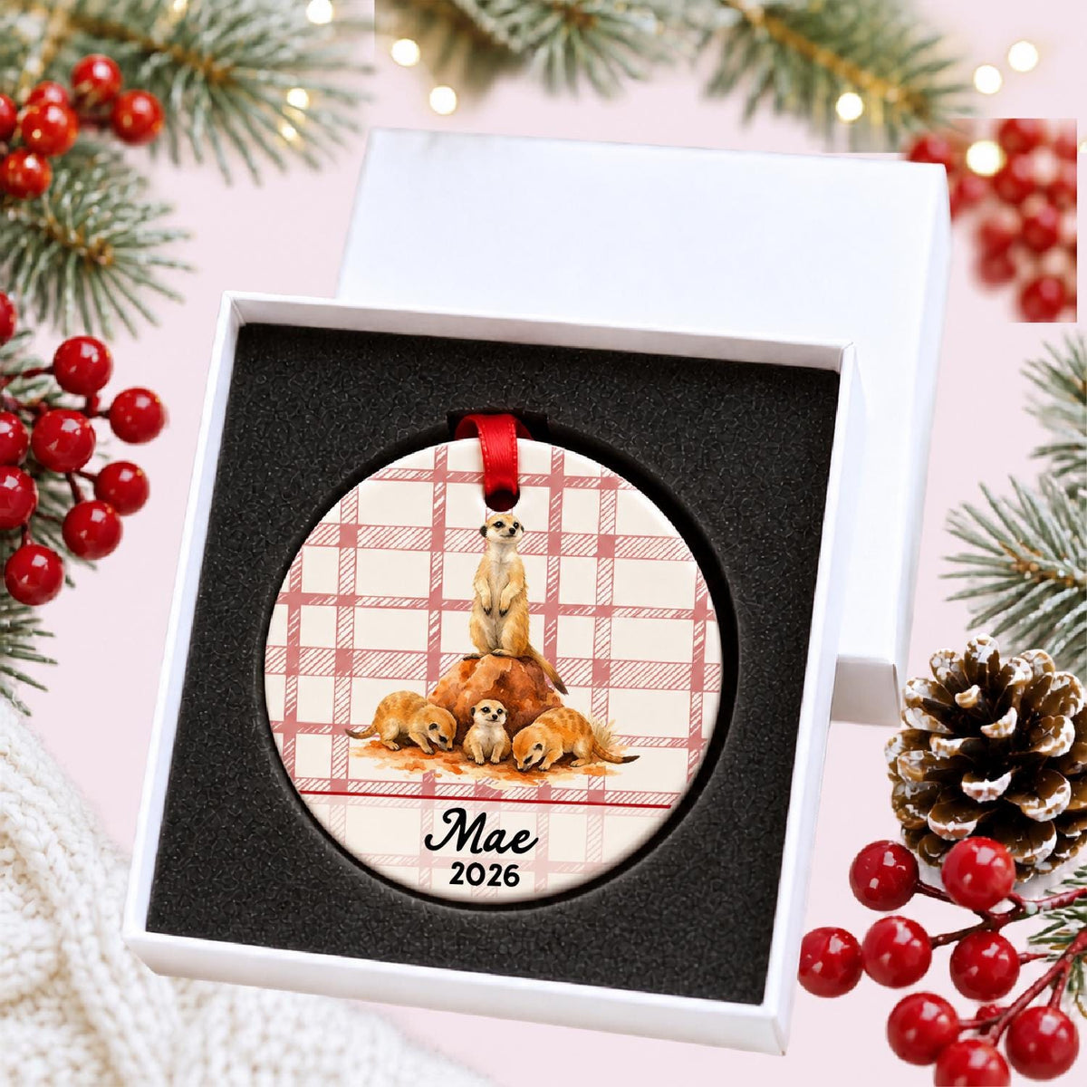 Personalized meerkat ceramic ornament with name and year on red plaid in a white gift box with protective foam