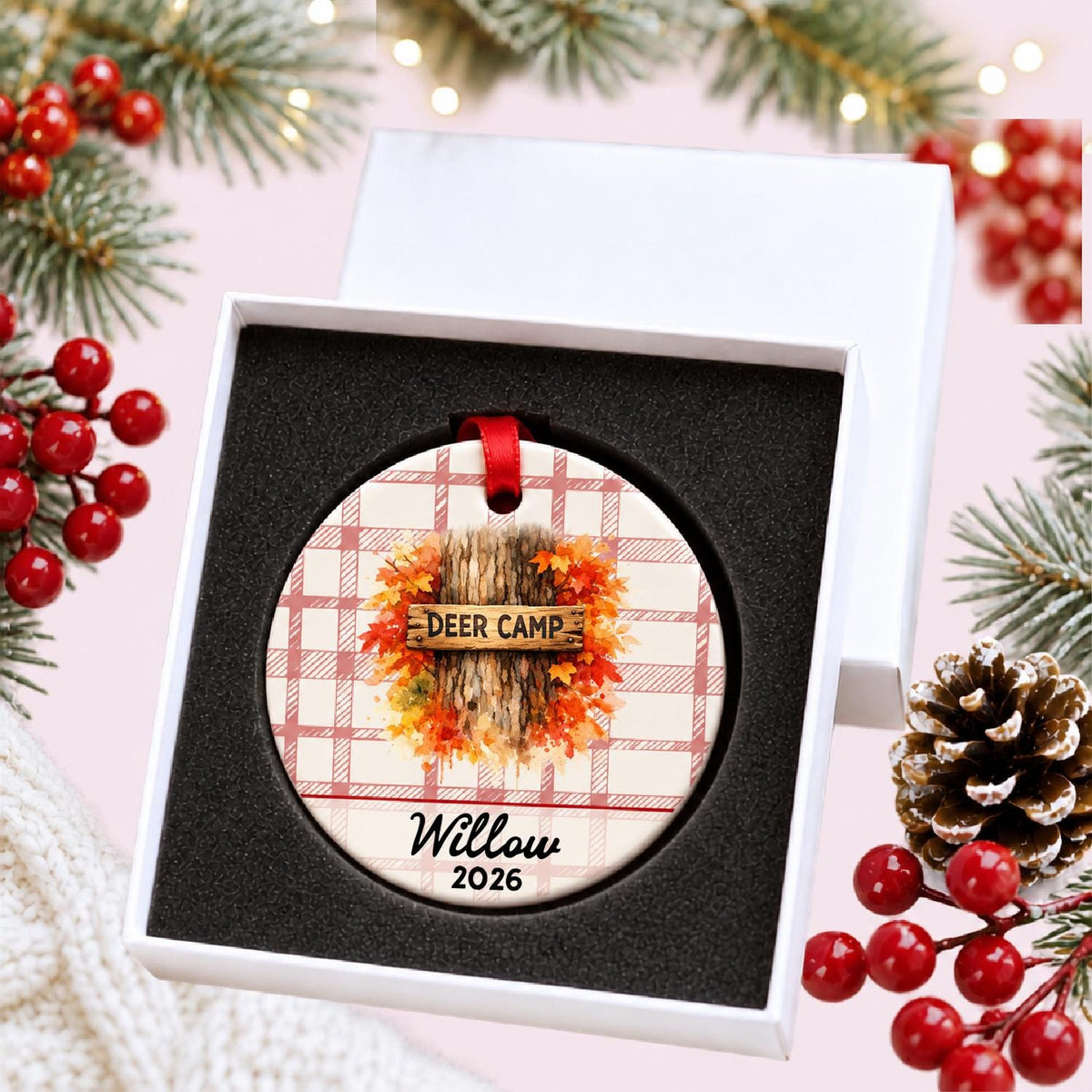 Personalized deer camp ceramic ornament with name and year on red plaid in a white gift box with protective foam