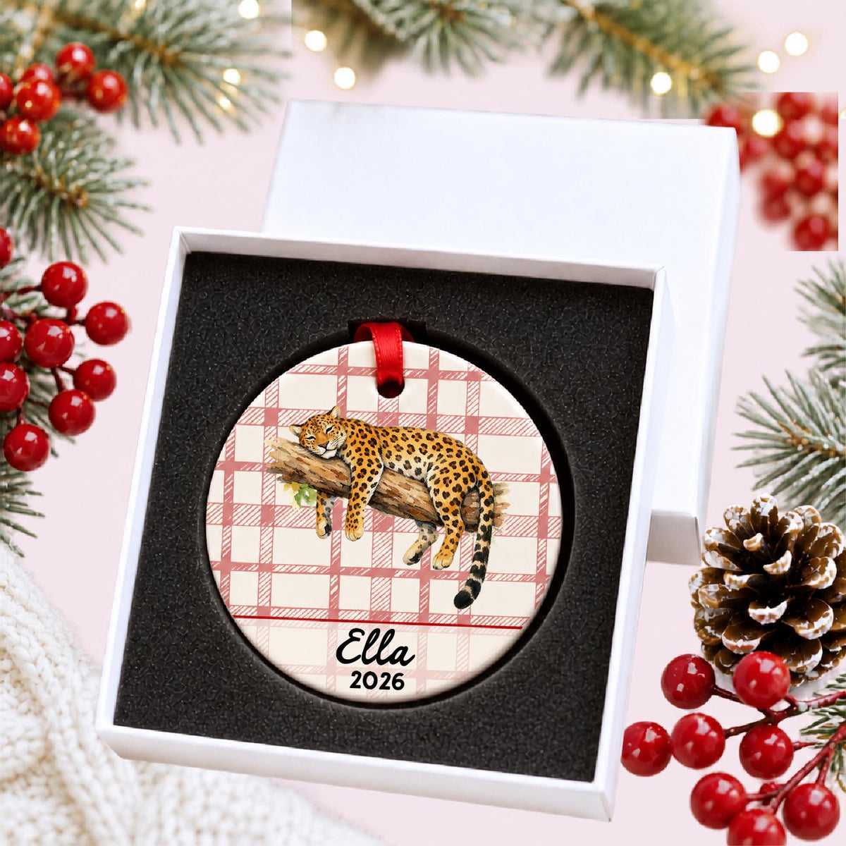 Personalized leopard ceramic ornament with name and year on red plaid in a white gift box with protective foam