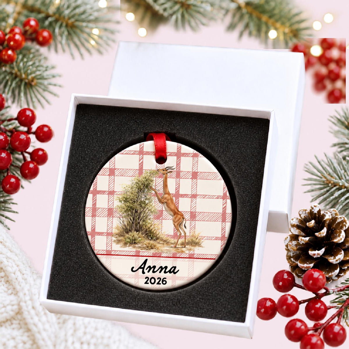 Personalized gerenuk ceramic ornament with name and year on red plaid in a white gift box with protective foam