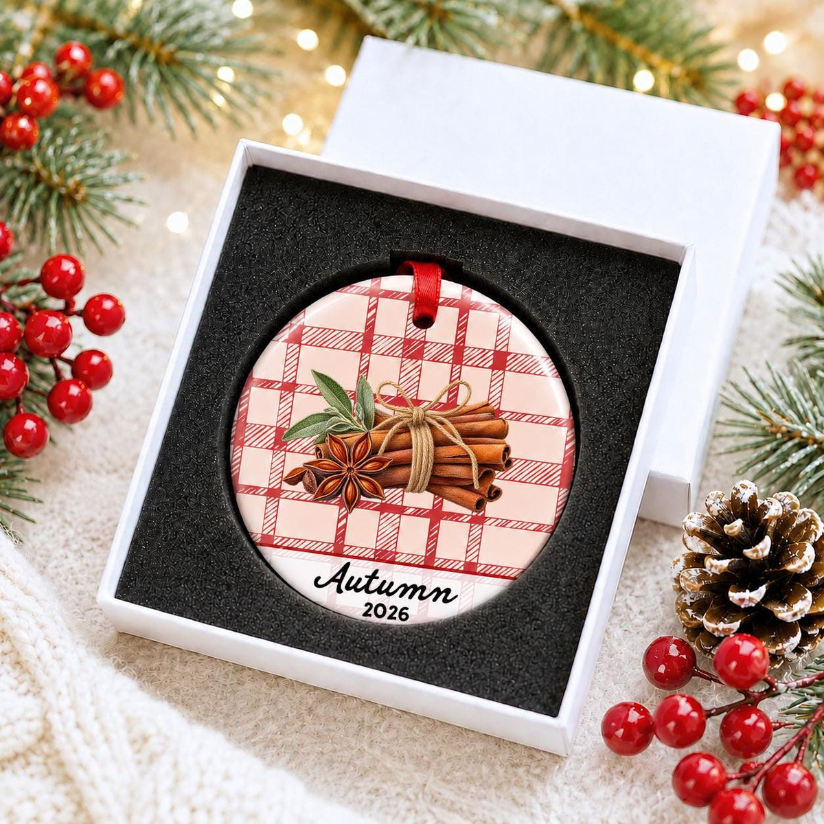 Personalized cinnamon stick ceramic ornament with name and year on red plaid in a white gift box with protective foam