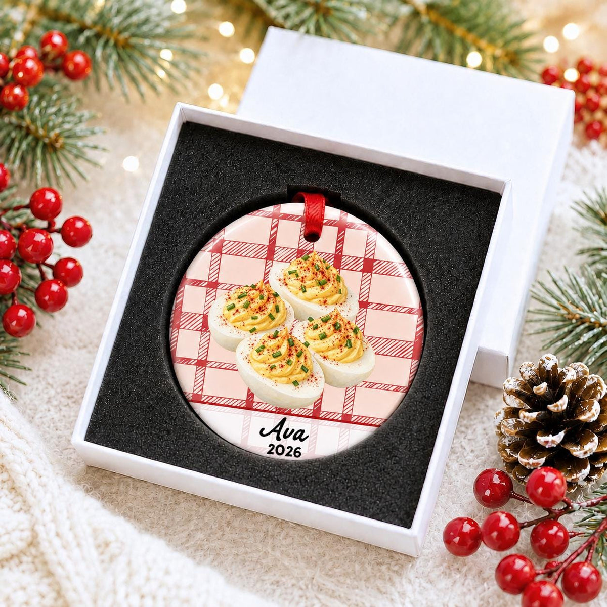 Personalized deviled eggs ceramic ornament with name and year on red plaid in a white gift box with protective foam