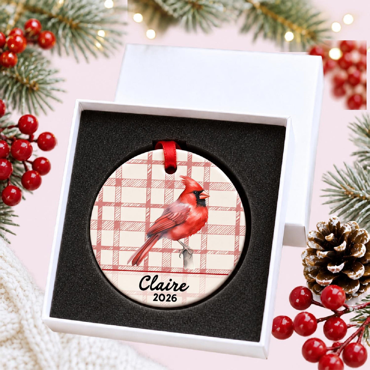 Personalized northern cardinal ceramic ornament with name and year on red plaid in a white gift box with protective foam