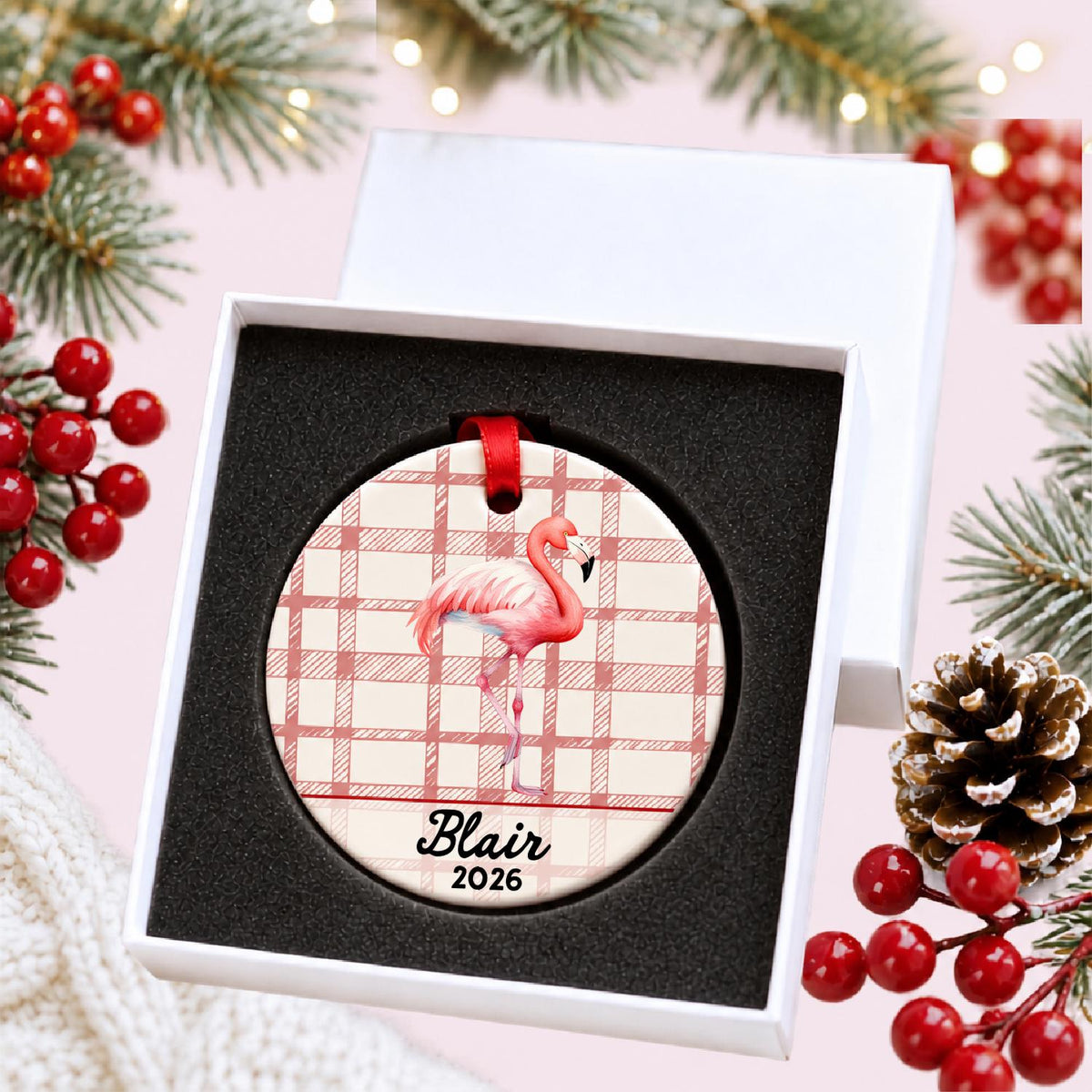Personalized flamingo ceramic ornament with name and year on red plaid in a white gift box with protective foam