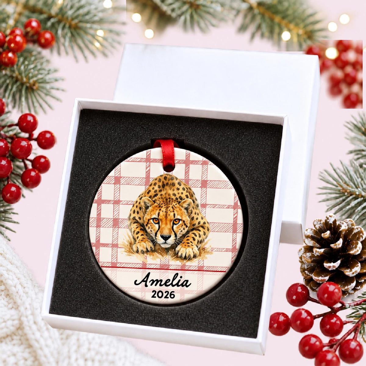 Personalized cheetah ceramic ornament with name and year on red plaid in a white gift box with protective foam