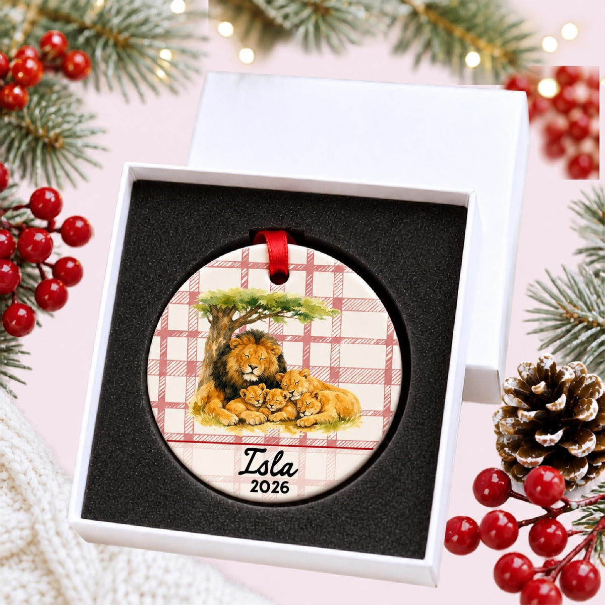 Personalized lion pride ceramic ornament with name and year on red plaid in a white gift box with protective foam
