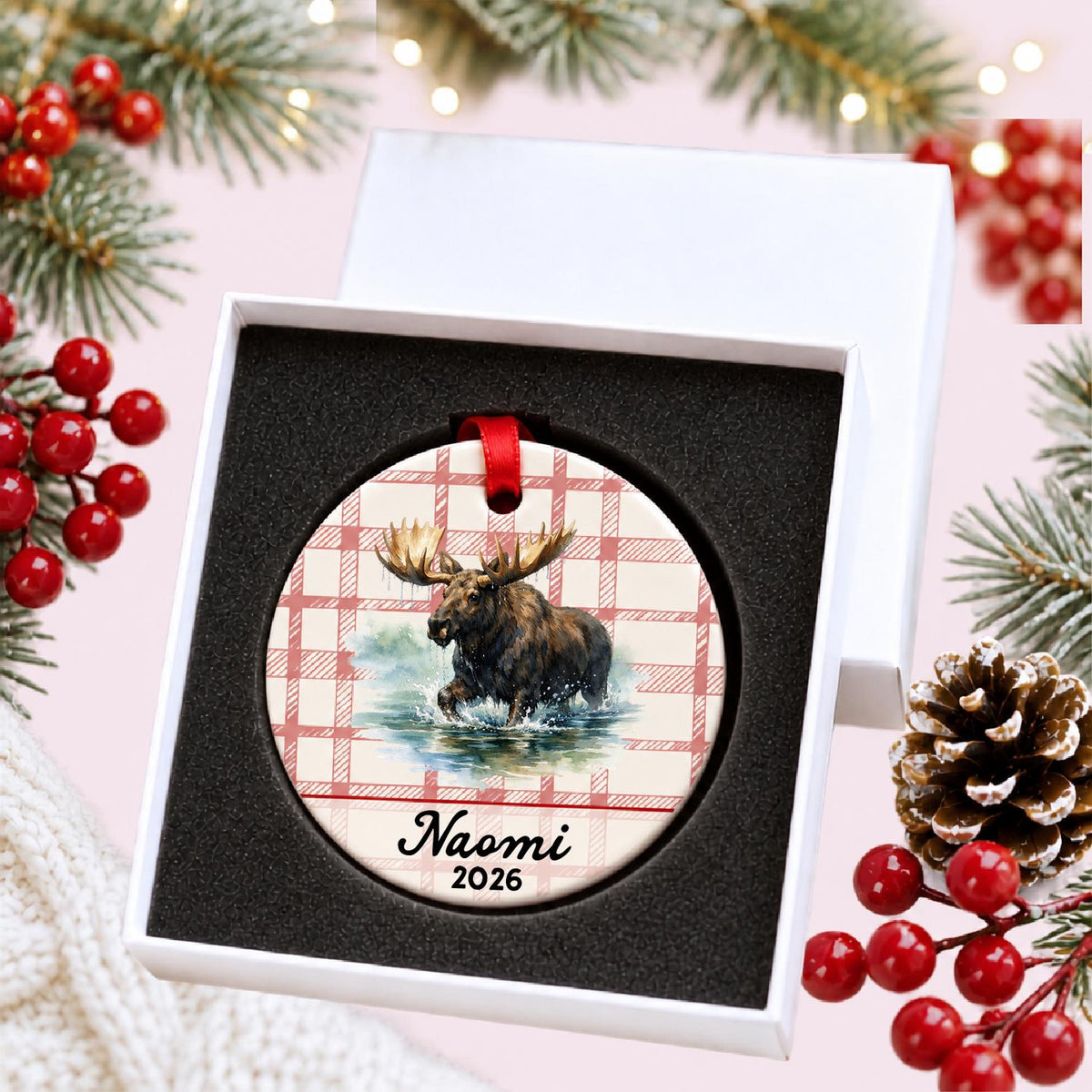 Personalized bull moose ceramic ornament with name and year on red plaid in a white gift box with protective foam