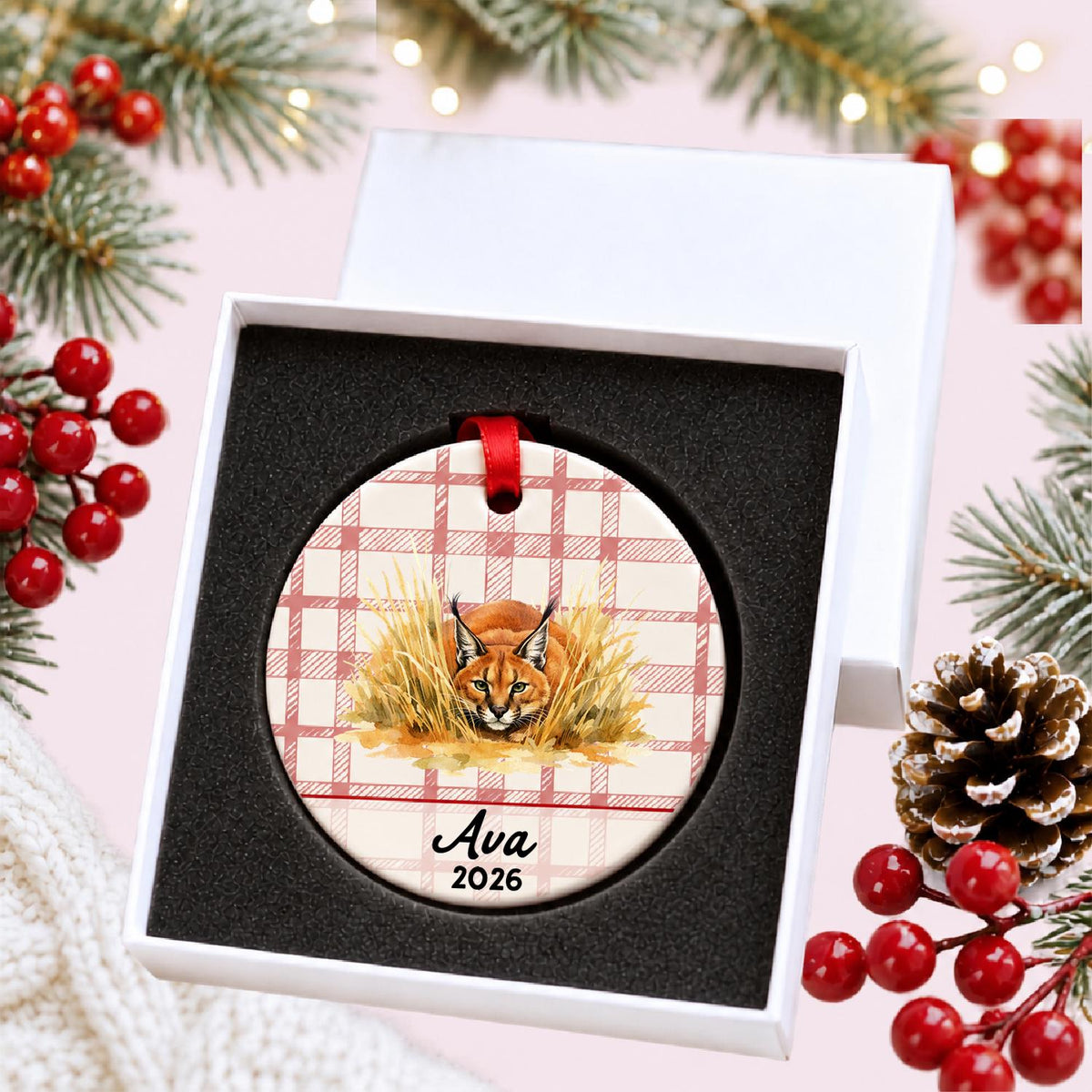 Personalized caracal ceramic ornament with name and year on red plaid in a white gift box with protective foam