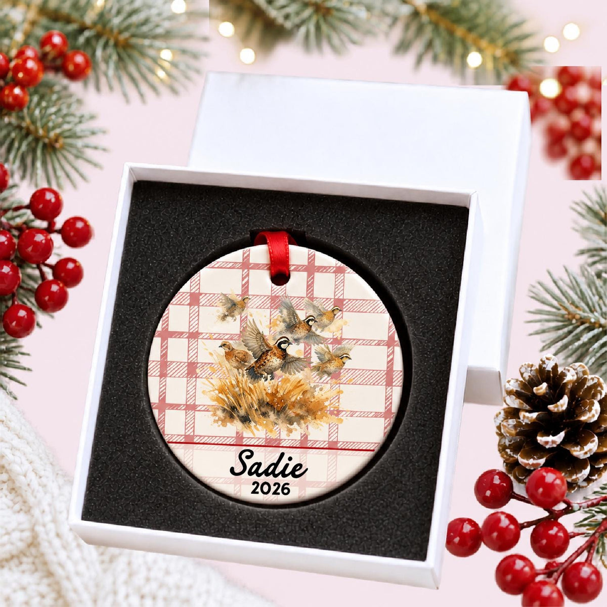 Personalized bobwhite quail ceramic ornament with name and year on red plaid in a white gift box with protective foam